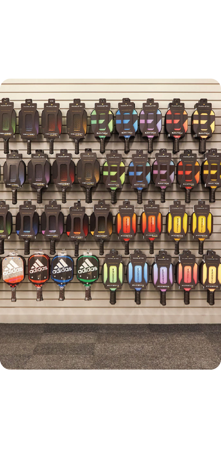A wall of pickelball racquets